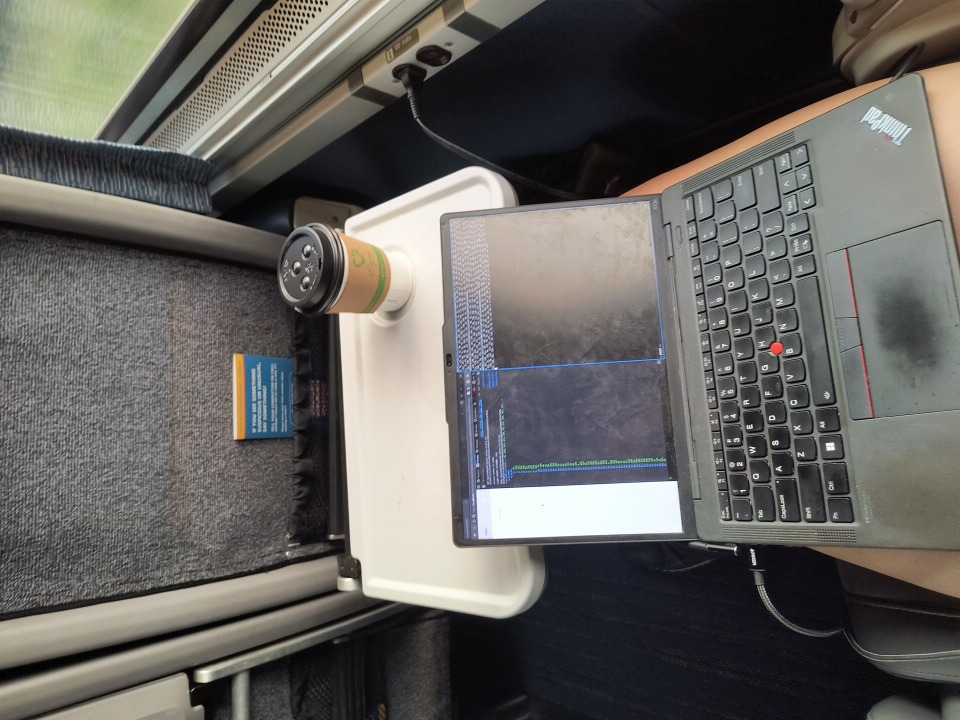 amtrak window seat with laptop and coffee on tray